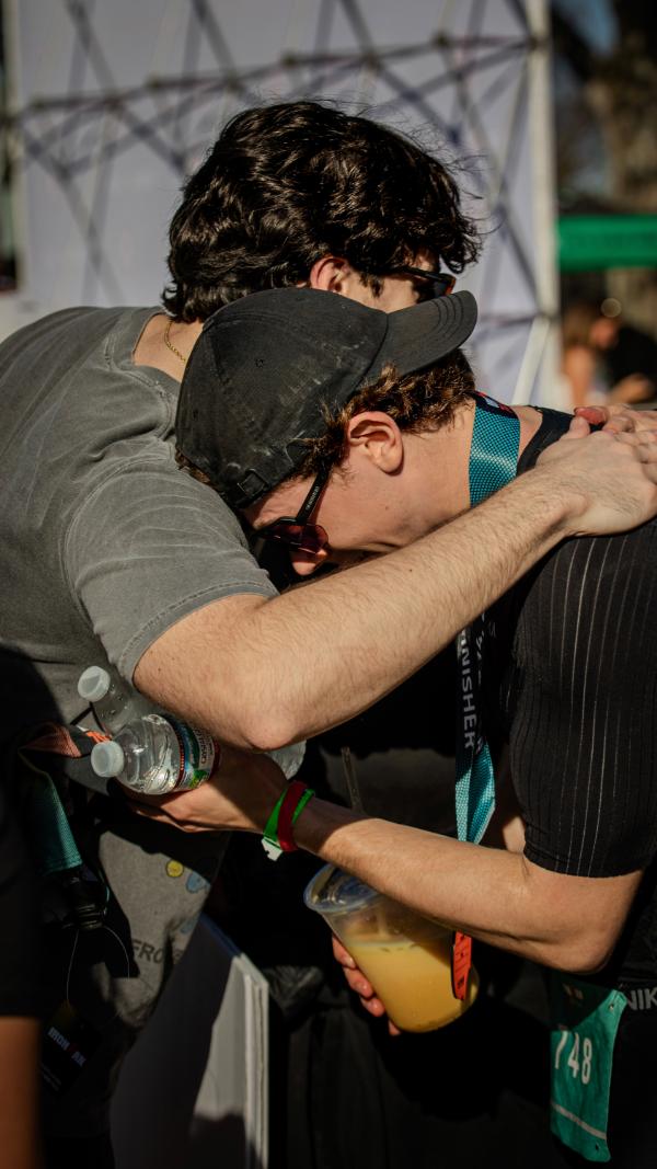 Aidan hugging a friend after the finish