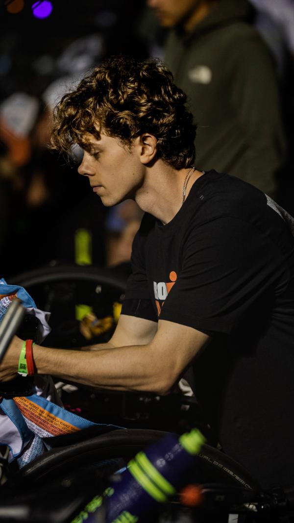Aidan setting up his bike in transition at night