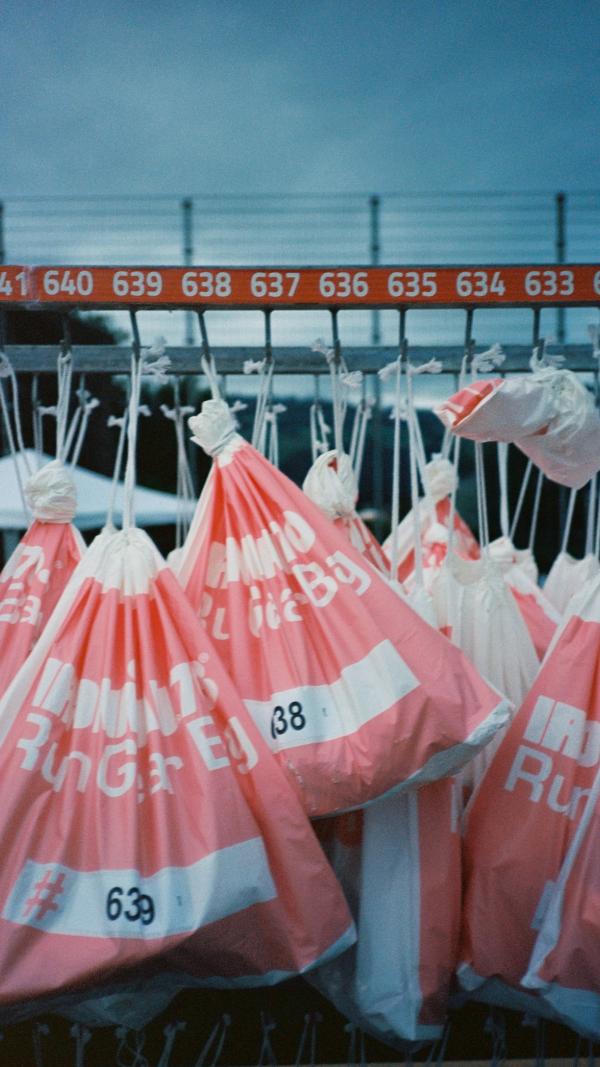 Rows of numbered red gear bags hanging in transition